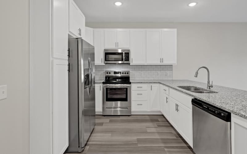 a kitchen with white cabinets